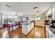 Open kitchen featuring a dining area, granite countertops, white cabinets and tile floors at 7118 Cherry Laurel Dr, Port Richey, FL 34668
