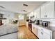 Bright kitchen featuring granite countertops, white cabinets, and stainless steel appliances at 7118 Cherry Laurel Dr, Port Richey, FL 34668
