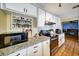 Modern kitchen featuring stainless steel appliances, granite countertops and white cabinetry at 7118 Cherry Laurel Dr, Port Richey, FL 34668