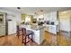 Bright eat-in kitchen with granite countertops, seating, and white cabinets at 7118 Cherry Laurel Dr, Port Richey, FL 34668