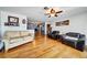 Spacious living room with hardwood floors, ceiling fan and comfortable seating area at 7118 Cherry Laurel Dr, Port Richey, FL 34668