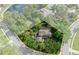 Aerial view of a landscaped property, featuring a home with a pool, surrounded by lush trees at 7268 Crystal Spring Run, Weeki Wachee, FL 34607