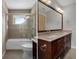 Bathroom with bathtub and shower, and granite countertop vanity with dual sinks at 7268 Crystal Spring Run, Weeki Wachee, FL 34607