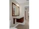 Bathroom vanity with square sink, wood framed mirror and lighting at 7268 Crystal Spring Run, Weeki Wachee, FL 34607