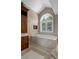 Bathroom includes a soaking tub with a view, custom cabinets and unique tile flooring at 7268 Crystal Spring Run, Weeki Wachee, FL 34607
