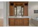 Bathroom vanity boasts custom wood cabinets, marble counters, and decorative mirrors at 7268 Crystal Spring Run, Weeki Wachee, FL 34607