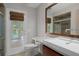 Bathroom featuring a glass shower, toilet, sink and pool views through door at 7268 Crystal Spring Run, Weeki Wachee, FL 34607