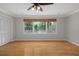 Bedroom featuring hardwood floors, recessed lighting, large windows, and closet at 7268 Crystal Spring Run, Weeki Wachee, FL 34607