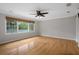 Bedroom featuring hardwood floors, crown molding, ceiling fan, and large windows at 7268 Crystal Spring Run, Weeki Wachee, FL 34607