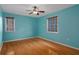 Bedroom with wood floors, ceiling fan, and two windows at 7268 Crystal Spring Run, Weeki Wachee, FL 34607