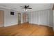 Bedroom with hardwood floors, recessed lighting, and an attached bathroom and closet space at 7268 Crystal Spring Run, Weeki Wachee, FL 34607
