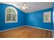 Bedroom has a large window and wood floors with a ceiling fan at 7268 Crystal Spring Run, Weeki Wachee, FL 34607