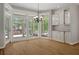 Dining area with hardwood floors, backyard views, and access to a pool and outdoor living area at 7268 Crystal Spring Run, Weeki Wachee, FL 34607