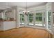 Dining area with hardwood floors, backyard views, and access to the kitchen and outdoor living at 7268 Crystal Spring Run, Weeki Wachee, FL 34607