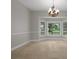 Dining area with large bay window featuring backyard view and elegant chandelier at 7268 Crystal Spring Run, Weeki Wachee, FL 34607