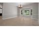 Formal dining area with elegant chandelier and three-window bay provides natural light at 7268 Crystal Spring Run, Weeki Wachee, FL 34607