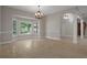 Open dining area with natural light from bay window and travertine tile floors at 7268 Crystal Spring Run, Weeki Wachee, FL 34607