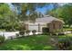 View of a beautiful two-story brick house featuring an attached three-car garage with a well-manicured front lawn at 7268 Crystal Spring Run, Weeki Wachee, FL 34607
