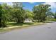 A beautiful home with mature trees providing shade and curb appeal on a sunny day at 7268 Crystal Spring Run, Weeki Wachee, FL 34607