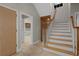 Foyer with tile flooring, wooden staircase, and view to kitchen at 7268 Crystal Spring Run, Weeki Wachee, FL 34607