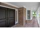 Inviting front porch with brick flooring and detailed architecture, creating a warm entrance at 7268 Crystal Spring Run, Weeki Wachee, FL 34607
