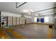 Spacious garage with storage cabinets, shelving, and sealed floors at 7268 Crystal Spring Run, Weeki Wachee, FL 34607