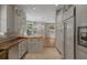 Well-equipped kitchen with custom cabinets, butcher block island and breakfast bar seating at 7268 Crystal Spring Run, Weeki Wachee, FL 34607