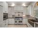 Well-appointed kitchen features custom cabinets, stone counters, and stainless steel appliances at 7268 Crystal Spring Run, Weeki Wachee, FL 34607