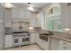 Custom kitchen with stone counters, large steel stove, copper sink and arched window at 7268 Crystal Spring Run, Weeki Wachee, FL 34607