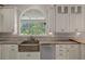 Well-lit kitchen features stone counters, copper sink, modern appliances, and ample cabinet space at 7268 Crystal Spring Run, Weeki Wachee, FL 34607