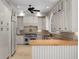 Bright kitchen with custom cabinets, butcher block island, stone counters, and stainless appliances at 7268 Crystal Spring Run, Weeki Wachee, FL 34607