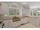 Bright kitchen boasts stone counters, a copper sink, and views of the backyard at 7268 Crystal Spring Run, Weeki Wachee, FL 34607