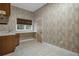 Well-lit laundry room featuring a window, cabinets, sink, and counter space at 7268 Crystal Spring Run, Weeki Wachee, FL 34607