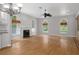 Spacious living room boasts hardwood floors, fireplace, and three large arched windows with views at 7268 Crystal Spring Run, Weeki Wachee, FL 34607