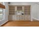 Living room featuring hardwood floors, built-in cabinets and shelving, and a window at 7268 Crystal Spring Run, Weeki Wachee, FL 34607