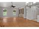 Elegant living room features hardwood floors, chandelier, and built-in bar area for entertaining at 7268 Crystal Spring Run, Weeki Wachee, FL 34607