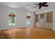 Open living room featuring hardwood floors, a fireplace, built-in shelving, and a window at 7268 Crystal Spring Run, Weeki Wachee, FL 34607