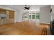 Spacious living room with hardwood floors, fireplace, built-in cabinets, and views to the kitchen and backyard at 7268 Crystal Spring Run, Weeki Wachee, FL 34607