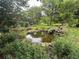 Scenic pond with rocks and plantings, creating a serene garden oasis at 7268 Crystal Spring Run, Weeki Wachee, FL 34607