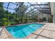 A full view of the pool area with outdoor plants, a ceiling fan, and a hot tub at 7268 Crystal Spring Run, Weeki Wachee, FL 34607