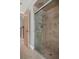 Tiled shower with glass door and mosaic tile accent at 7268 Crystal Spring Run, Weeki Wachee, FL 34607