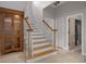 Entryway staircase with wooden banister and cabinet with tile flooring at 7268 Crystal Spring Run, Weeki Wachee, FL 34607