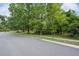 A peaceful suburban street with well-maintained sidewalks and lush green trees at 7268 Crystal Spring Run, Weeki Wachee, FL 34607