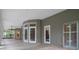 Sunroom features neutral paint, tile flooring, and access doors to the pool and patio at 7268 Crystal Spring Run, Weeki Wachee, FL 34607