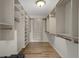 Spacious walk-in closet with custom shelving, cabinetry, and wood floors at 7268 Crystal Spring Run, Weeki Wachee, FL 34607