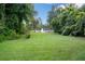 Manicured yard with view of pond and fountain at 7268 Crystal Spring Run, Weeki Wachee, FL 34607