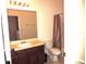 Bathroom features a vanity with sink, a toilet, and a shower at 7650 Red Mill Cir, New Port Richey, FL 34653