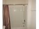 Bathroom with tub/shower combo and decorative shower curtain at 7650 Red Mill Cir, New Port Richey, FL 34653