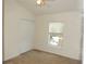 This cozy bedroom features a window with blinds and a closet at 7650 Red Mill Cir, New Port Richey, FL 34653