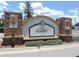 Welcoming entrance to Little Ridge community, featuring a decorative stone sign and manicured landscaping at 7650 Red Mill Cir, New Port Richey, FL 34653